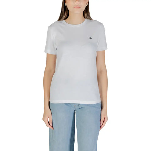 Woman wearing Calvin Klein Jeans White Short Sleeve Round Neck T Shirt with light blue jeans