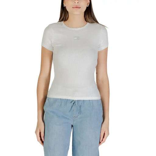 Woman wearing white short-sleeve T-shirt and light blue drawstring pants for Tommy Hilfiger collection