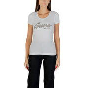 Woman wearing Guess Women White Rhinestone Round Neck Tee with graphic and black pants