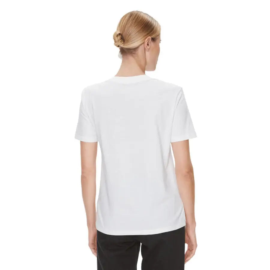 Woman in Calvin Klein Jeans white t-shirt for product feature