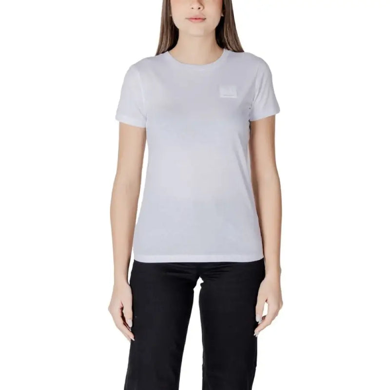 Woman wearing Black Crewneck T Shirt with white T shirt and black pants on a model