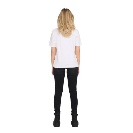 Woman wearing a white T-shirt and ripped black jeans for the Women’s White T-Shirt and Ripped Black Jeans product display