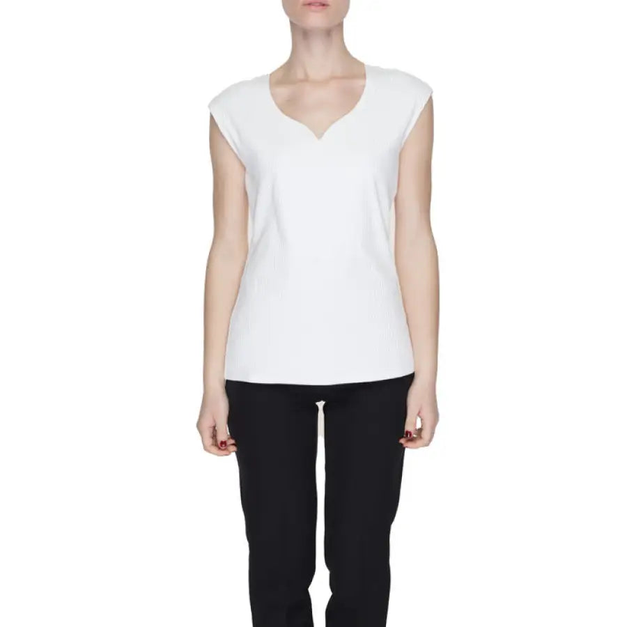 
                      
                        Urban style clothing: Woman in Street One V-neck white top, embodying urban city fashion
                      
                    