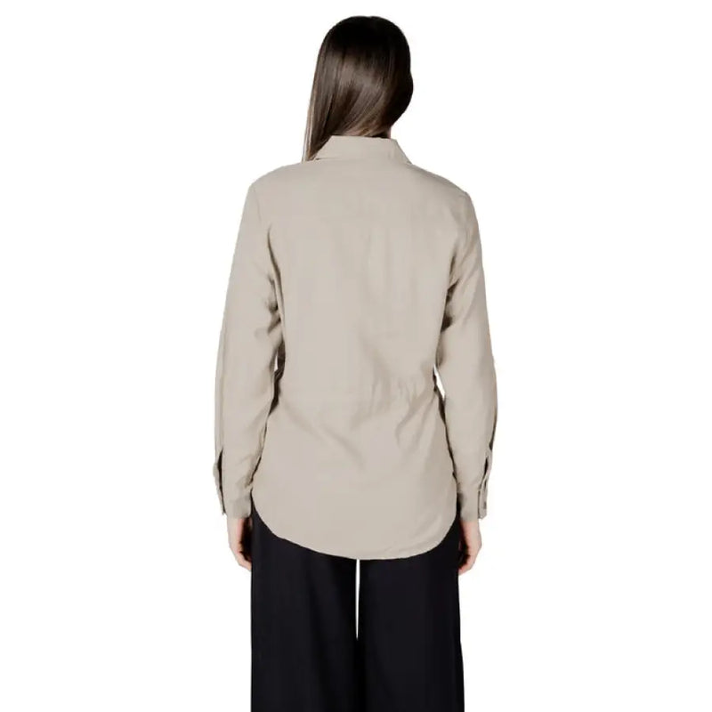 Woman wearing a beige button-down drawstring shirt from Womens Beige Button Down Drawstring Shirt collection