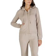 Woman wearing a beige hooded tracksuit from Liu Jo with rhinestones and a zip sweatshirt