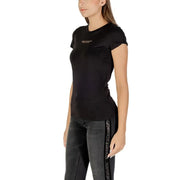 Woman wearing Armani Exchange black printed crew neck T-shirt with rolled sleeves and black jeans with side stripe