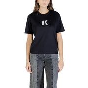 Woman wearing black crew-neck T-shirt with white K graphic and dark wash wide-leg jeans