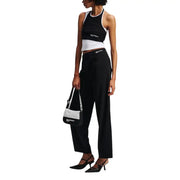 Woman wearing black and white crop top with wide-leg trousers and slingback heels