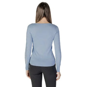 Woman wearing a light blue long-sleeved V neck sweater from Womens Light Blue V Neck Sweater collection
