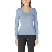 Woman wearing a light blue V-neck sweater from Womens Light Blue V Neck Sweater collection