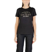 Woman wearing short-sleeved black Guess T-shirt with silver GUESS Los Angeles graphic