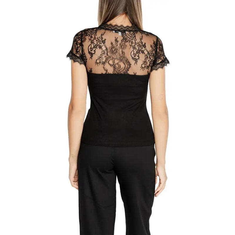 Woman wearing Morgan De Toi black V neck T shirt with sheer lace back and black trousers