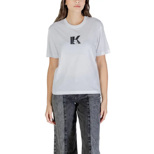 Woman wearing Karl Lagerfeld Jeans white printed round neck T shirt with black IK logo