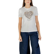 Woman wearing white organic cotton crew-neck T-shirt with heart-shaped leopard print design