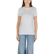 Woman wearing white short-sleeve T-shirt with light blue wide-leg jeans for Guess Active collection