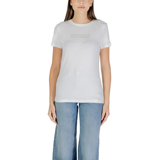Woman wearing white short-sleeve T-shirt with light blue wide-leg jeans for Guess Active collection