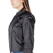 Women black moto jacket by Blauer with shiny nylon finish and zippered pockets in bomber style