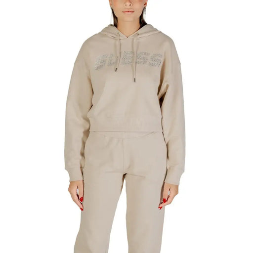 Women’s beige hooded sweatshirt and matching sweatpants from Guess with rhinestone details