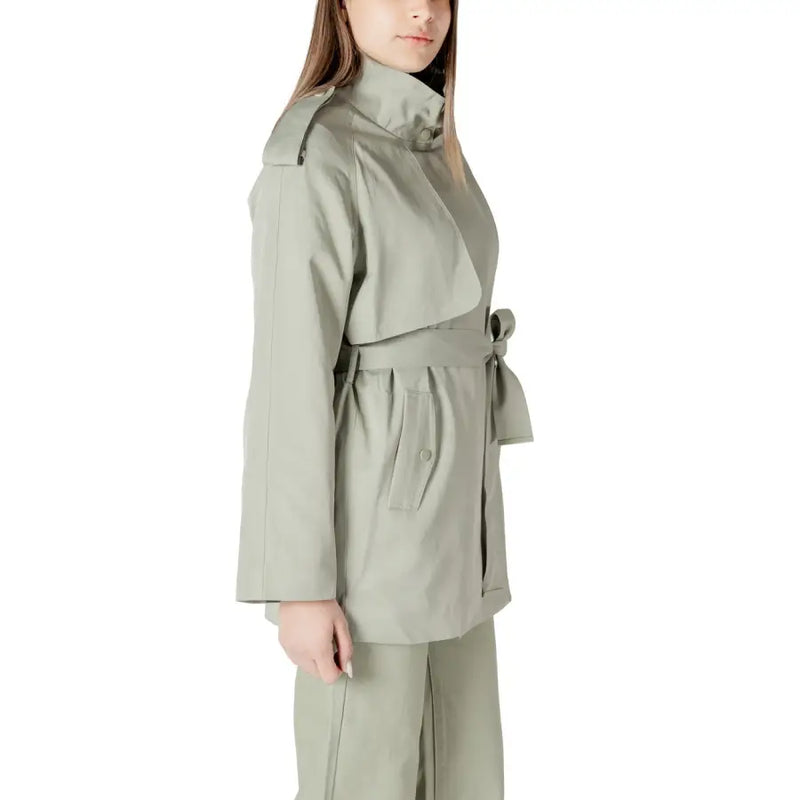 A sleek olive green women’s belted trench coat blazer with structured shoulders and a belted waist