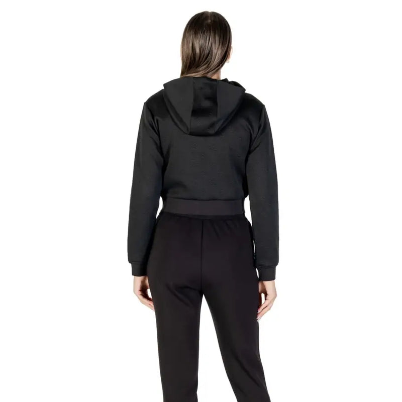 Women’s black cropped hoodie and sweatpants set from Guess Active for fall and winter