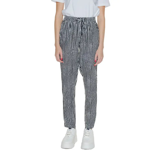 Women’s black geometric trousers with lace detail featuring high-waisted elastic drawstring waistband in black and white