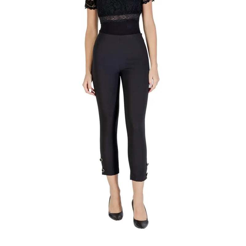 Women’s black high-waisted capri trousers with buckle cuffs, paired with a lace top and heels