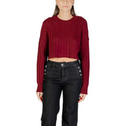 Woman wearing dark red cable-knit sweater and black wide-leg jeans for fall winter fashion