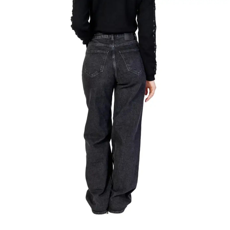 Women’s black wide leg jeans in dark-wash denim with a relaxed fit and classic back pockets shown from the back view