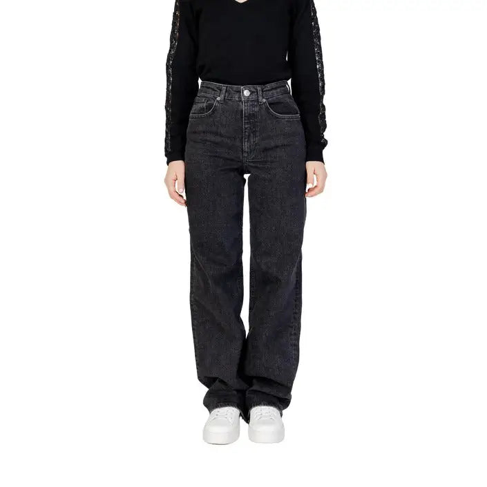 Woman wearing Women’s Black Wide Leg Jeans and black top showcasing stylish attire