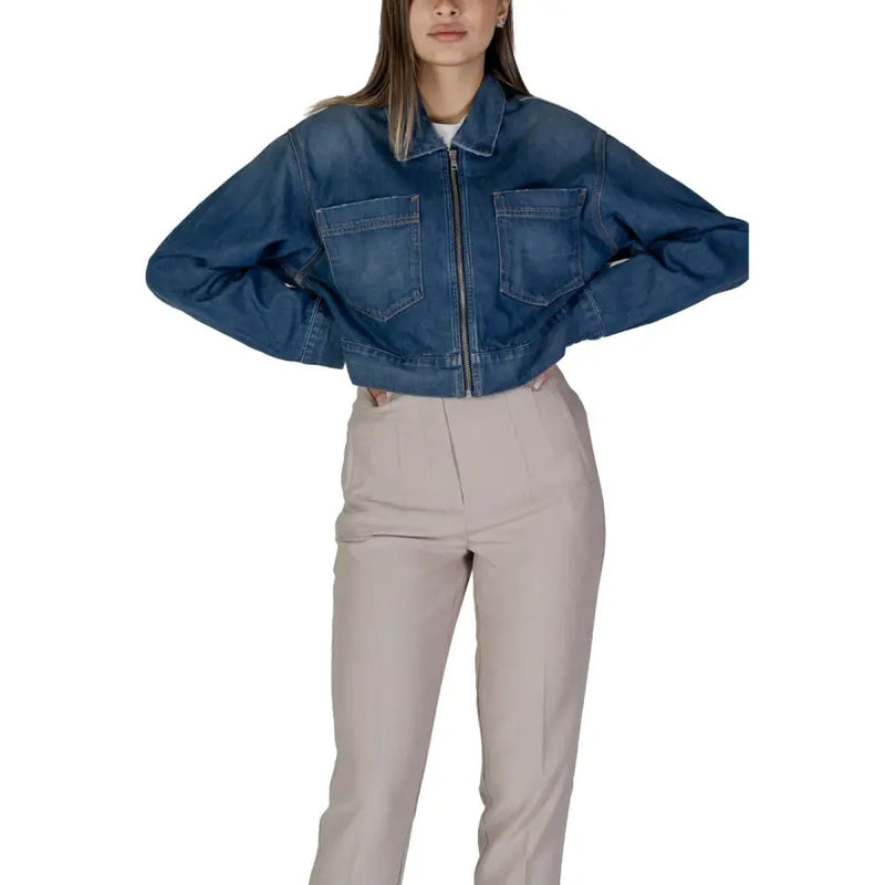 Women’s blue denim zip up blazer with two front pockets and zipper closure in cropped jacket style