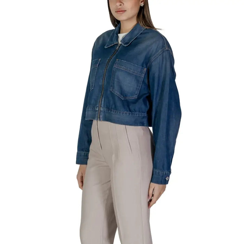 Women’s dark blue denim zip up blazer featuring a cropped cut, front zipper, and two chest pockets