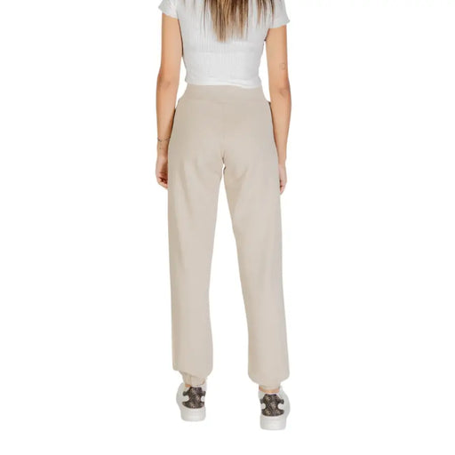 Women’s beige high-waisted cotton trousers with front pockets and elastic cuffs