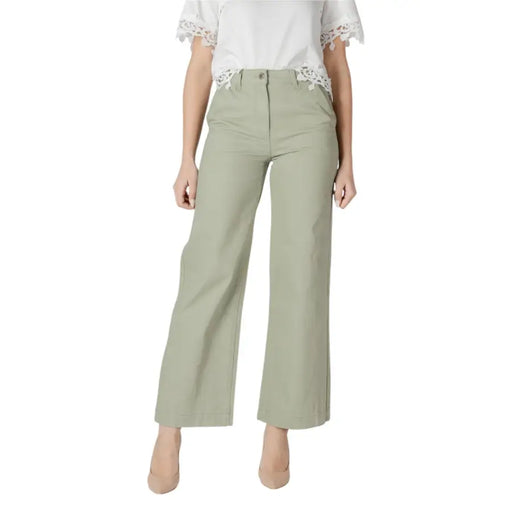 Women’s light green wide leg pants with a tailored fit and subtle front pleats in olive green fabric