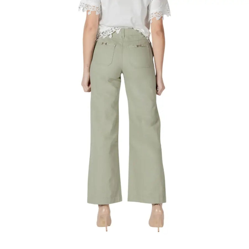 Women’s light green wide leg pants in olive with subtle texture and decorative metal accents on back pockets view
