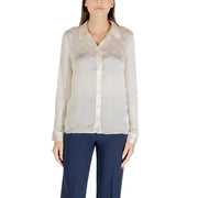Women wearing beige classic long sleeve round neck shirt with navy trousers by Guess