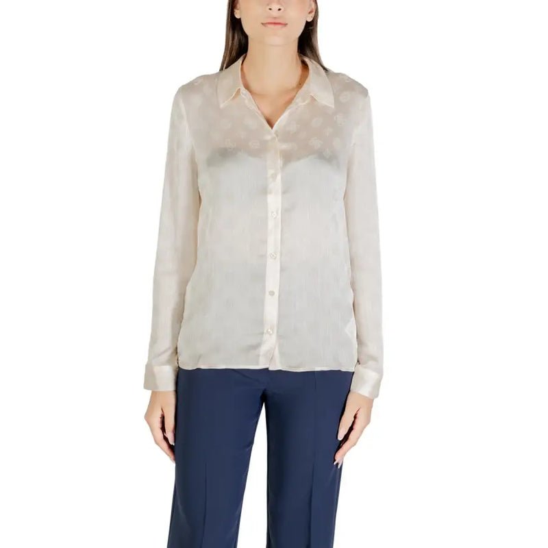 Women wearing beige classic long sleeve round neck shirt with navy trousers by Guess