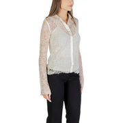 Women’s long-sleeved sheer lace white shirt over camisole with black trousers