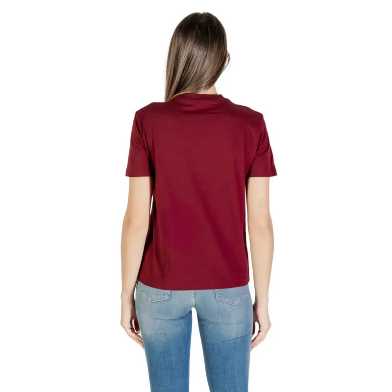 Women wearing Calvin Klein Jeans Bordeaux round neck short sleeve maroon T-shirt and blue jeans