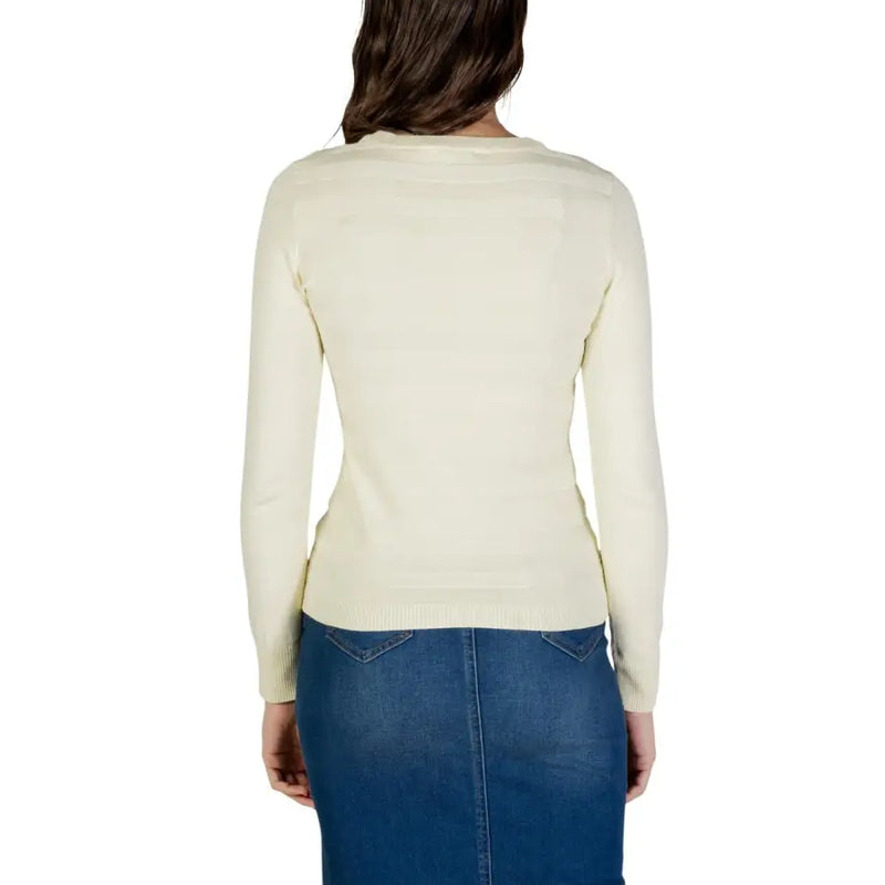 Cream-colored long sleeve knit sweater with simple crew neckline and ribbed hem made of viscose material