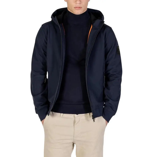 Navy blue down jacket with orange zipper and hood, likely from a luxury brand.
