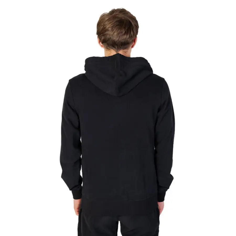 Young boy in black Emporio Armani hoodie showcasing urban style clothing