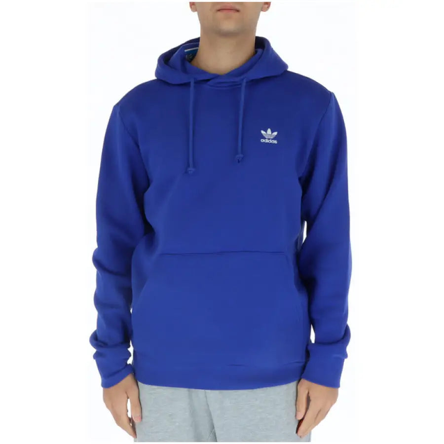Young man in blue Adidas hoodie showcasing urban city style clothing